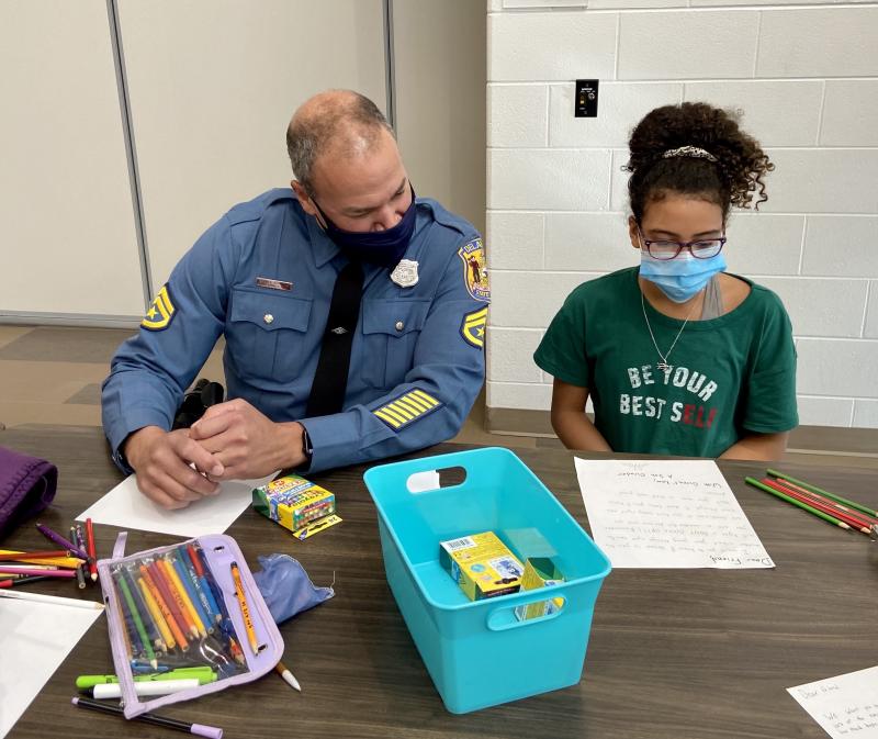School Resource Officer and Detective Chad Harmon reads a letter written by fifth-grader Kayla Billman before starting on his own letter.